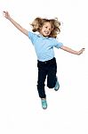 Energetic Young Child Jumping High Stock Photo
