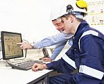 Engineers Discussing In Front Of Pc Stock Photo