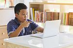 Excited Child Reading Online Laptop Computer Content At Library Stock Photo