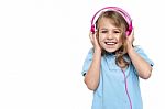Excited Girl Enjoying Music Through Headphones Stock Photo