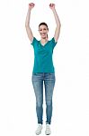Excited Woman Raising Her Arms Up Stock Photo