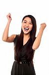 Excited Woman With Clenched Fists Stock Photo