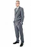 Experienced Businessman With Hands In Pockets Stock Photo