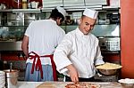 Expert Chefs At Work Inside Restaurant Kitchen Stock Photo