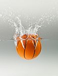 Falling Basketball Into Water Stock Photo