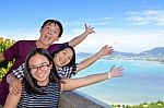 Family Of Tourists Inviting To See The Sea In Phuket, Thailand Stock Photo