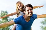 Father And Daughter Having Fun Outdoors Stock Photo