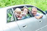 Father Enjoying Car Drive With His Kids Stock Photo