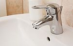 Faucet In A White Sink Stock Photo