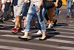 Feet Of Pedestrians Walking On The Crosswalk Stock Photo