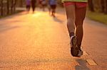 Feet Of Runner In Evening Light Stock Photo