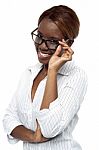 Female Adjusting Her Spectacle Stock Photo