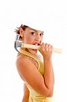 Female Architect Biting Hammer Stock Photo