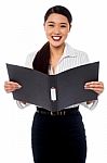Female Assistant Reviewing File Stock Photo