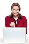 Female Business Executive Pointing At Laptop Stock Photo