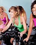 Female Cycling In Fitness Club Stock Photo