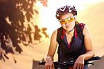 Female Cyclist In Sportswear Riding Bicycle Stock Photo