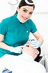 Female Dentist Examines A Patient Stock Photo