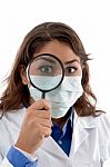 Female Doctor Inspecting With Magnifying Glass Stock Photo