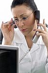 Female Doctor Talking Over Phone Stock Photo