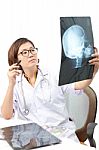 Female Doctor Watching On Head Skull X-ray Film Stock Photo