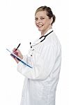 Female Doctor Writing Clipboard Stock Photo