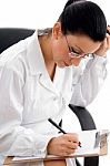 Female Doctor writing on clipboard Stock Photo