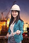 Female Engineer With Construction Plant Against Building Stuctur Stock Photo