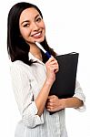 Female Executive Holding Business File And Pen Stock Photo