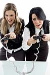 Female Partners Playing Game And Holding Remote Stock Photo