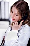 Female Physician Talking Over Phone Stock Photo