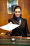 Female Receptionist Giving Paper Stock Photo