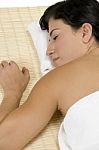 Female Sleeping On Bamboo Mat Stock Photo