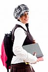 Female Student In Cap With Her School Bag And Study Material Stock Photo