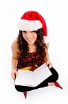 Female With Christmas Hat And Blank Book Stock Photo