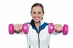 Female Working Out With Pink Dumbbells Stock Photo