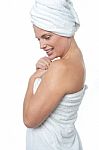 Female Wrapping Herself In Towel After Hot Spa Stock Photo