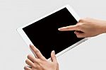 Finger Being Pointed On Tablet Screen Stock Photo