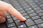 Finger Pressing Enter Key Of A Computer Keyboard Stock Photo