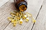 Fish Oil Capsule On Wood Background Stock Photo