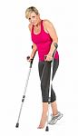 Fitness Woman Walking With Crutches Stock Photo
