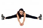 Flexible Woman Stretching Her Legs Stock Photo