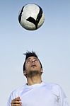 Football Player Striking The Ball At The Stadium Stock Photo