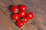 Fresh Tomatoes On The Dark Wooden Table Stock Photo