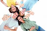Friends Lying Down With Thumbs Up Stock Photo