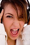 Front View Of Screaming Young Woman Listening Music Stock Photo