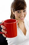 Front View Of Smiling Female Executive Holding Coffee Mug Stock Photo