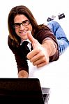 Front View Of Smiling Laying Male With Thumbs Up Stock Photo