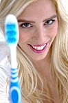 Front View Of Smiling Woman Holding Toothbrush Stock Photo