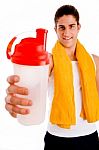 Front View Of Young Man Offering Drink Stock Photo